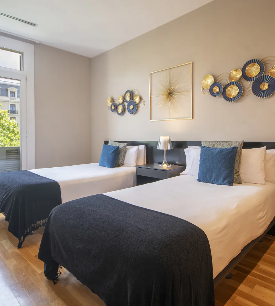 Suite Celia twin bedroom with blue textiles and decorative wall art