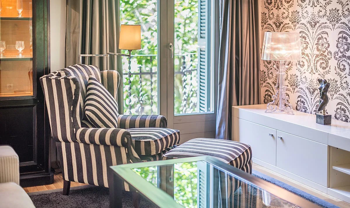 Casa Verdú armchair beside the balcony doors