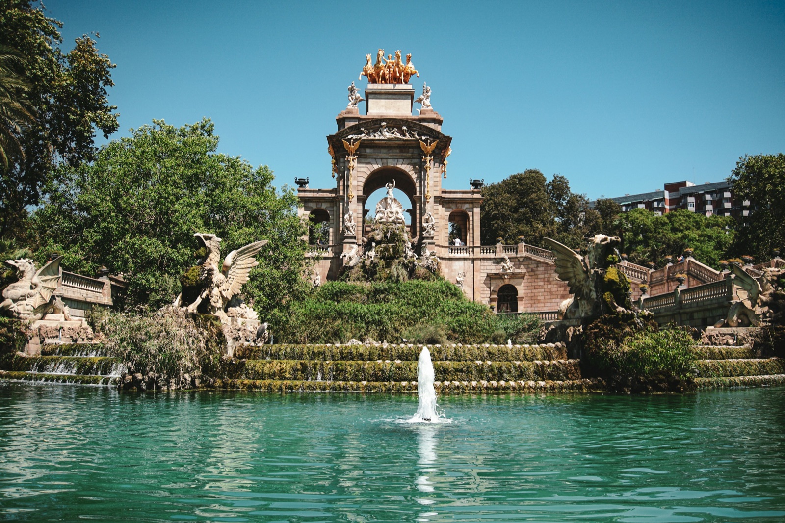 The monumental Cascada fountain framed by trees in Barcelona's Parc de la Ciutadella