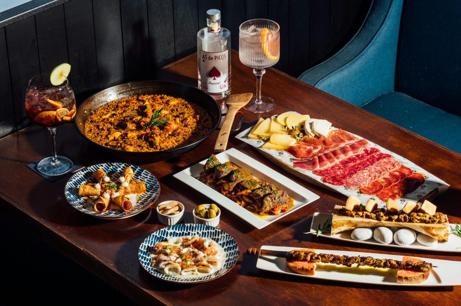Shared dishes, glasses and flowers arranged across a Barcelona dining table