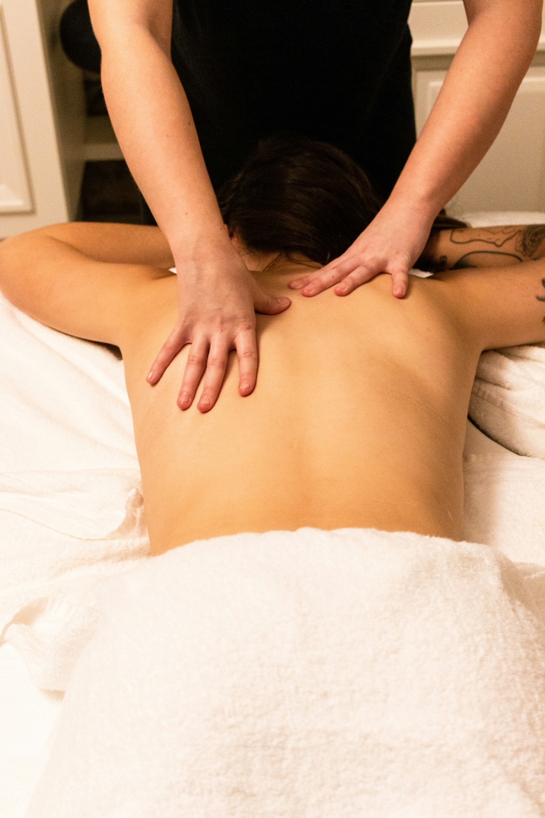 A spa therapist giving a relaxing back massage