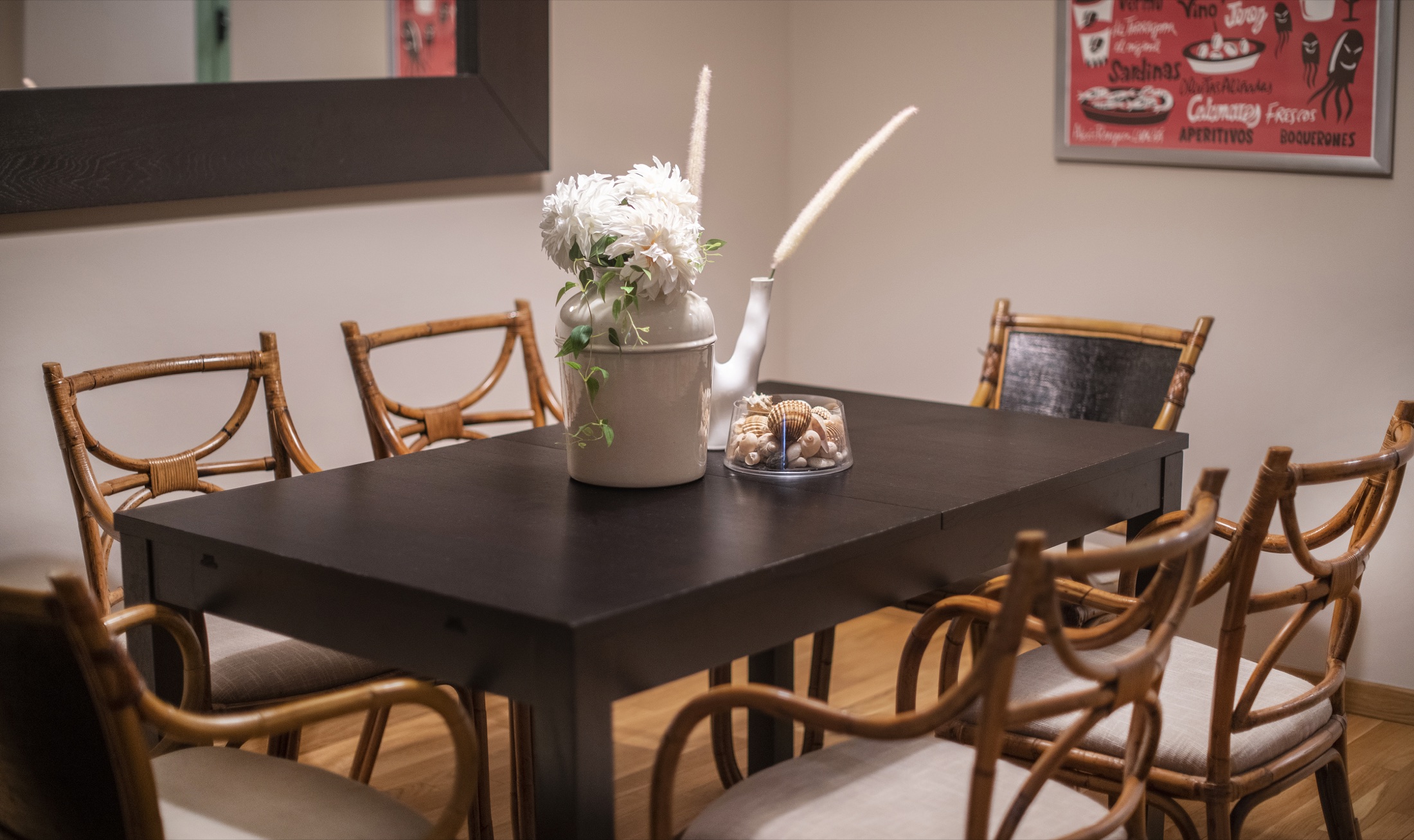 Suite Bella dining room with woven chairs and a dark wood table