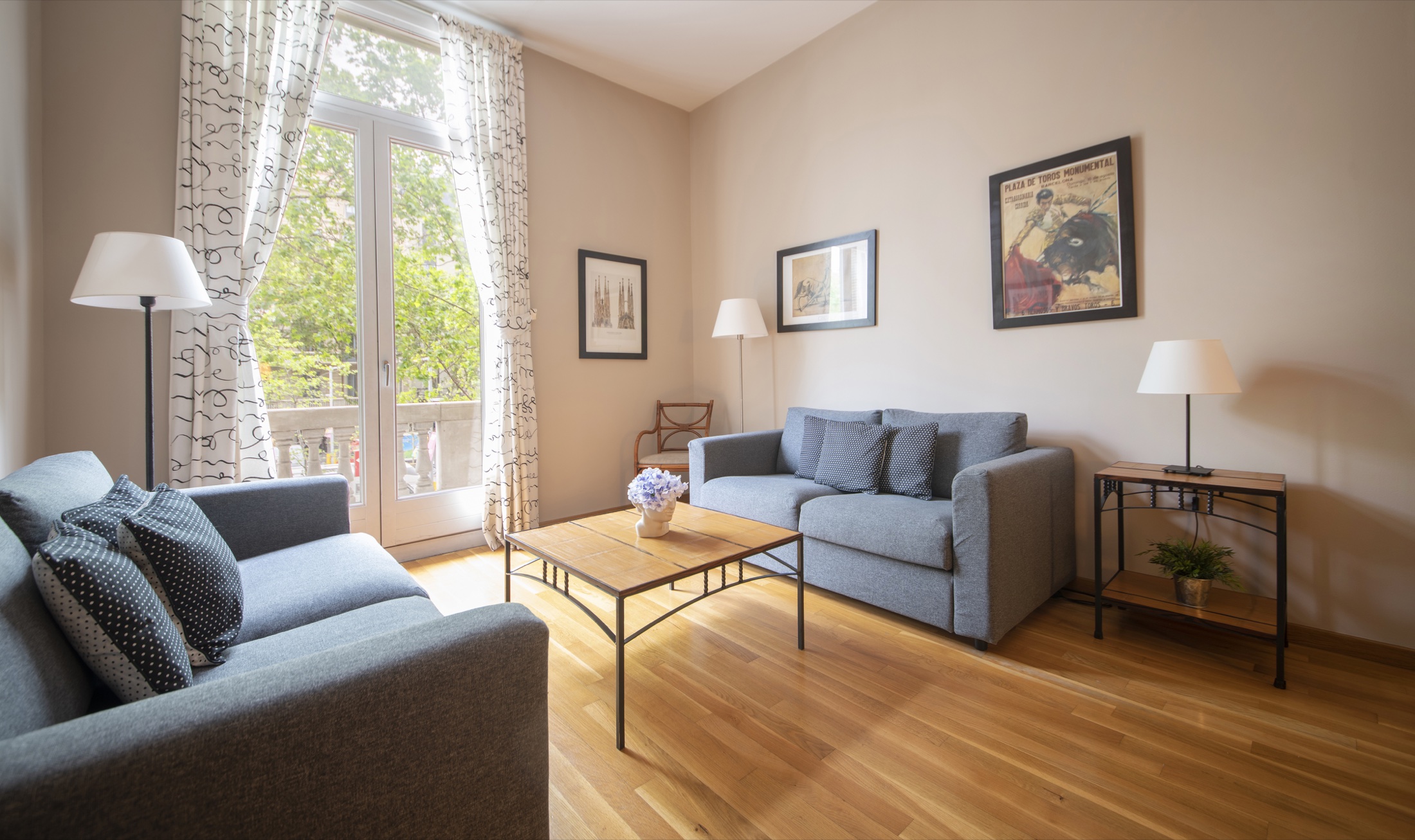 Suite Bella living room arranged around tall balcony windows