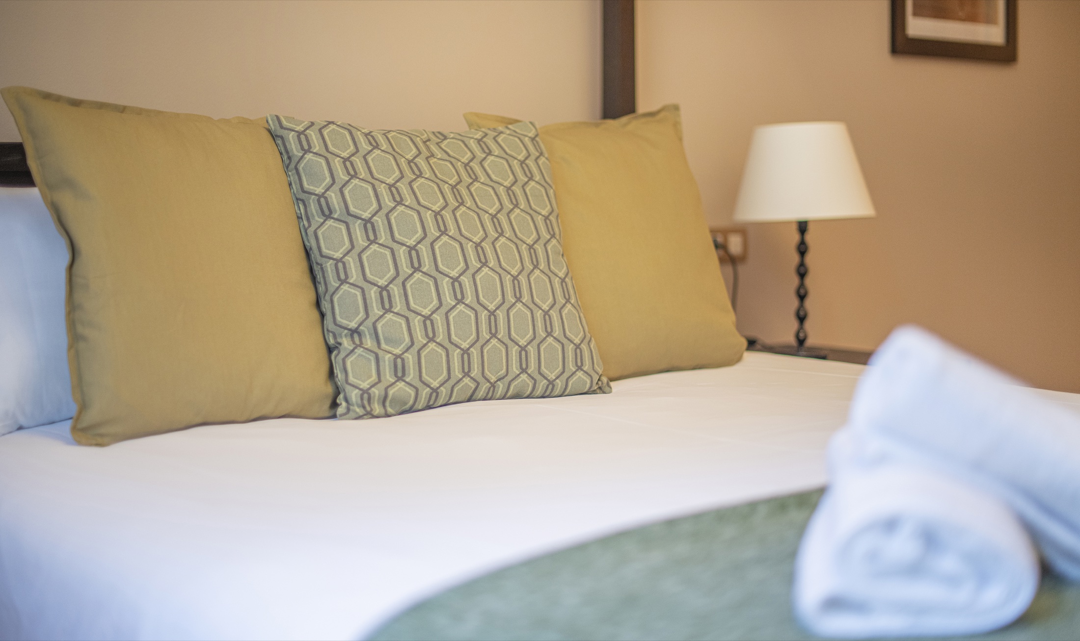 Suite Bella principal bedroom detail with soft furnishings and a neatly made bed