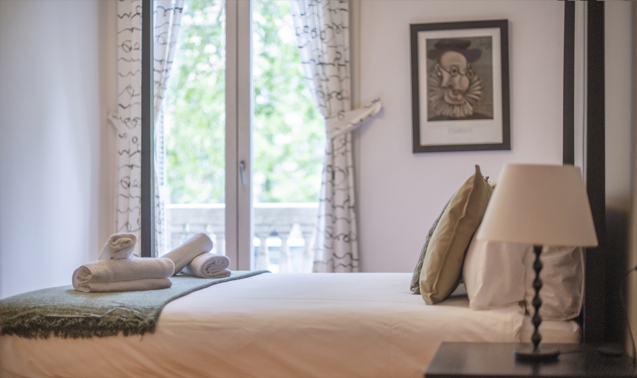Bedroom 2 in Suite Bella with one double bed beside the balcony window