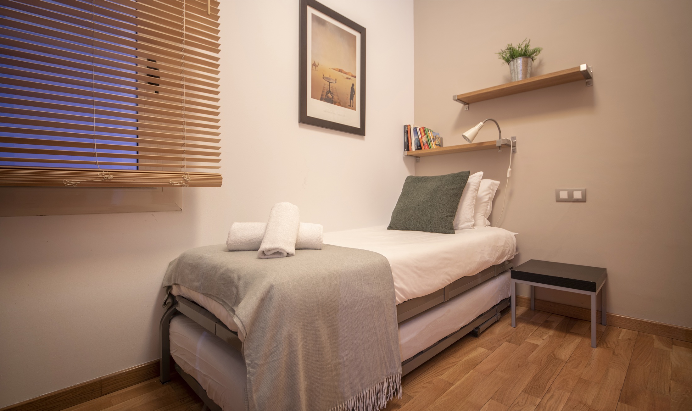 Suite Bella single bedroom with built-in wardrobe and reading shelf