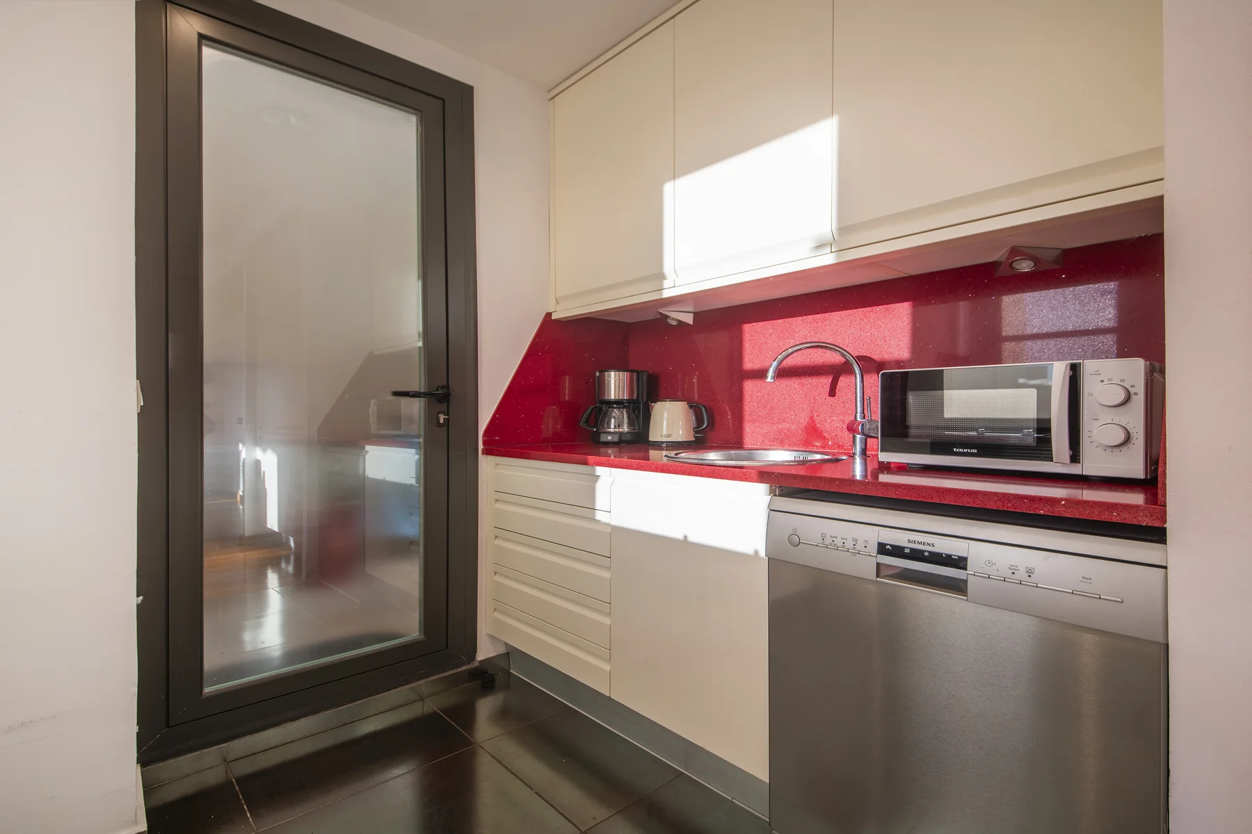 Suite Divina galley kitchen with dishwasher and microwave