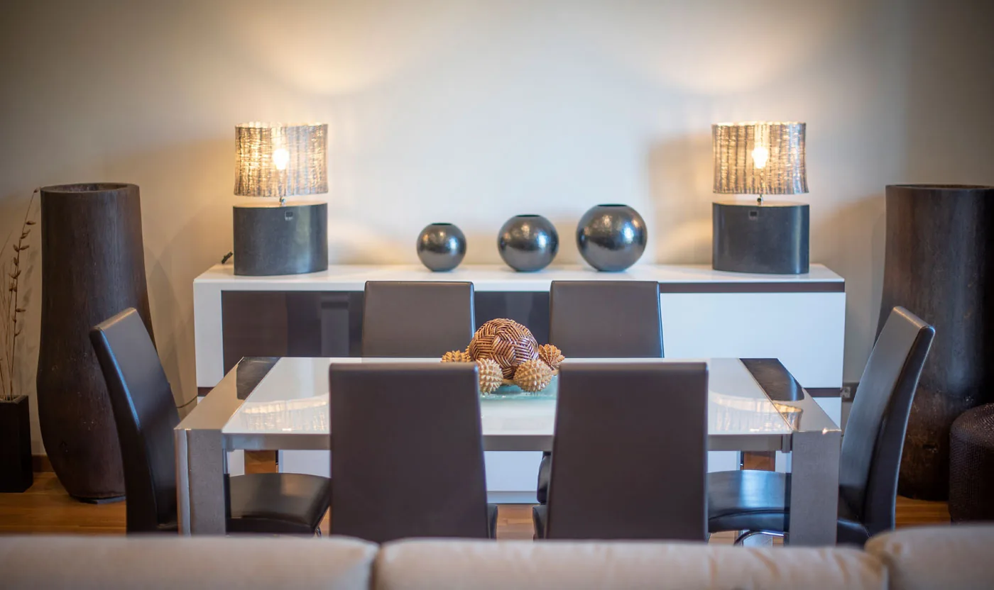 Dining table framed by the balcony windows in Suite Sagrada